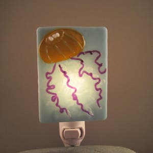 Jellyfish Hand-crafted Orange, Yellow, Purple, and Clear Glass Night Light on Light Blue Glass