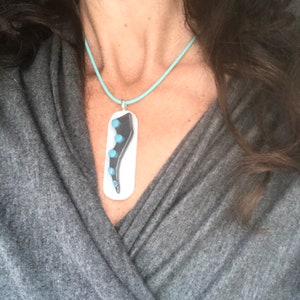 Gray and Blue Octopus Tentacle on White Glass Pendant on a Silicone Cord Necklace