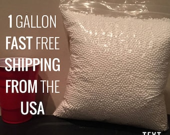 May include: A white plastic bag filled with white polystyrene packing peanuts. The bag is sitting on a dark surface. The text "1 GALLON FAST FREE SHIPPING FROM THE USA" is visible in the image.
