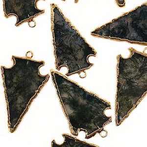 May include: Ten green and black agate arrowhead pendants with gold-toned metal accents. Each pendant has a loop for attaching to jewelry.
