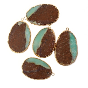 May include: Five oval-shaped green and brown gemstone pendants with gold trim. The pendants have a natural, organic look and are perfect for jewelry making.