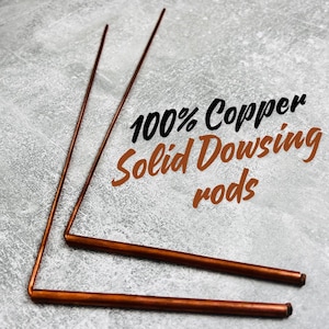 May include: Two copper dowsing rods, also known as divining rods, are laid out on a gray surface. The text "100% Copper Solid Dowsing rods" is superimposed on the image.