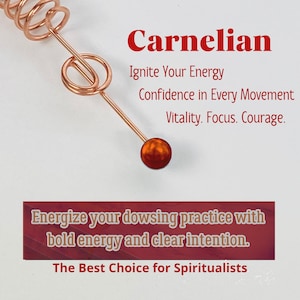 May include: A copper-colored dowsing rod with a carnelian gemstone at the end. The text on the image reads "Carnelian" and "Ignite Your Energy". The image also includes the text "Energize your dowsing practice with bold energy and clear intention."