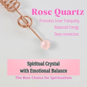 May include: A rose quartz crystal with copper-colored wire accents. The image includes text that reads "Rose Quartz" and "Spiritual Crystal with Emotional Balance". The crystal is a pale pink color.