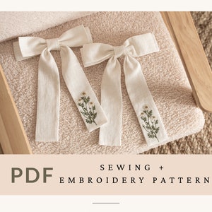 Peut inclure: Deux nœuds en lin blanc avec des motifs floraux brodés en vert. Le texte "SEWING + EMBROIDERY PATTERN" est en bas de l'image. Le texte "WHITE-COUTURIER.COM" est en bas de l'image.