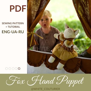 May include: A fox hand puppet made of fabric, with a white face, brown ears, and a yellow and brown dress. The puppet is set against a backdrop of brown curtains and a child in the background. Text on the image reads "PDF", "SEWING PATTERN + TUTORIAL", and "Fox Hand Puppet".