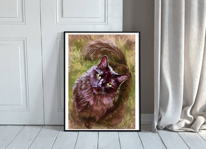 May include: A framed art print of a black cat with green eyes, looking upwards. The cat has fluffy fur and is set against a background of green and brown tones, resembling grass. The artwork is displayed on a white wall.