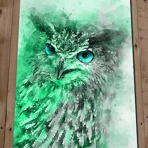 May include: A watercolour painting of an owl with bright blue eyes. The owl is rendered in shades of green and white, with a soft, ethereal background.