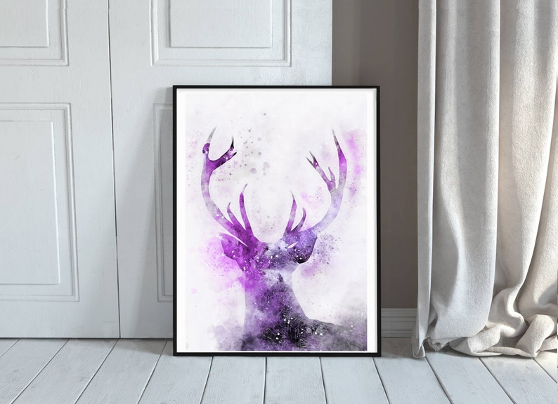 May include: A purple watercolor painting of a deer head with antlers. The deer is silhouetted against a white background with a subtle purple and gray watercolor wash.