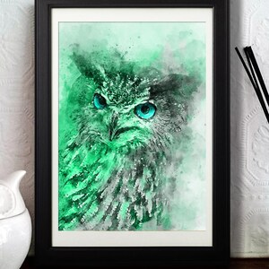 May include: A watercolour painting of an owl with bright blue eyes. The owl is rendered in shades of green and grey, with a soft, ethereal background.