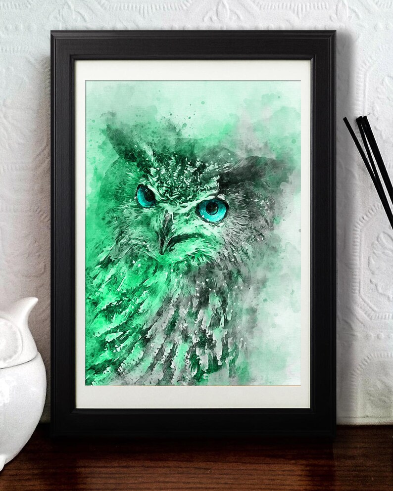 May include: A watercolour painting of an owl with bright blue eyes. The owl is rendered in shades of green and grey, with a soft, ethereal background.