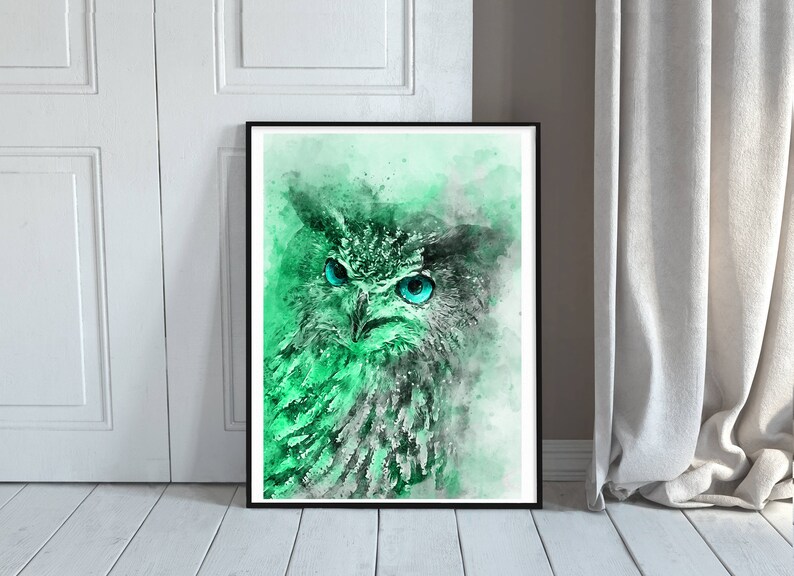 May include: A watercolour painting of an owl with bright blue eyes. The owl is rendered in shades of green and grey, with a soft, ethereal background.