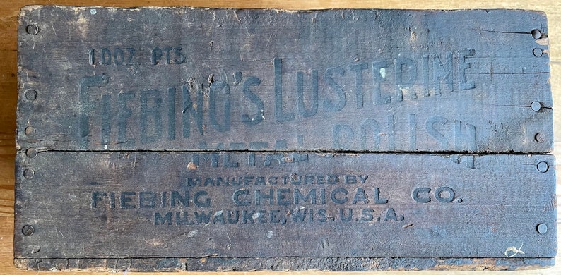 May include: A wooden box with black lettering that reads "1007 PTS.  Fiebings LUSTRE  METAL POLISH  MANUFACTURED BY  FIEBING CHEMICAL CO.  MILWAUKEE, WIS. U.S.A."