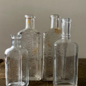 4 Antique Apothecary Clear Embossed Bottles
