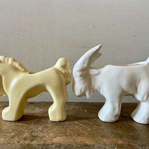 May include: Two ceramic animal planter figurines. A white goat planter and a yellow horse planter.