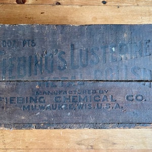 May include: A wooden box with black lettering that reads "1000 PTS. FRING'S LUSTREINE METAL POLISH MANUFACTURED BY FIEBING CHEMICAL CO. MILWAUKEE, WIS. U.S.A."