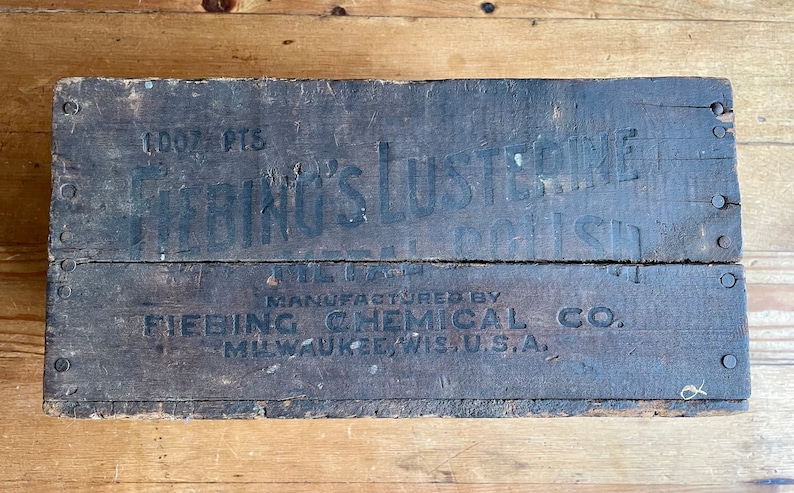 May include: A wooden box with black lettering that reads "1000 PTS. FRING'S LUSTREINE METAL POLISH MANUFACTURED BY FIEBING CHEMICAL CO. MILWAUKEE, WIS. U.S.A."