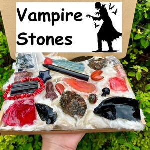 May include: A box filled with various crystals and stones, including black obsidian, red agate, and clear quartz. The box is labeled "Vampire Stones".