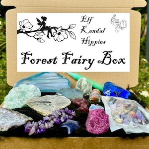 May include: A brown cardboard box filled with various crystals and stones. The box is labeled "Elf Kendal Hippies Forest Fairy Box".