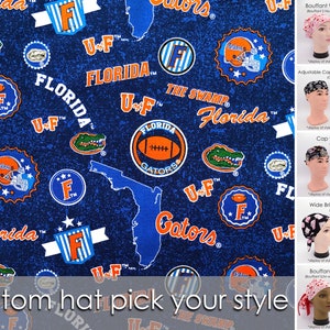 May include: Blue fabric with repeating patterns of the University of Florida Gators logo, footballs, and the state outline. The words "Florida", "Gators", and "U-F" are also visible. The image also shows different styles of hats.