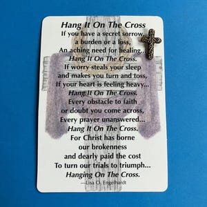May include: A white card with the text "Hang It On The Cross" and a poem, accompanied by a small, ornate gold-colored cross. The card has a purple cross graphic and is set against a blue background.