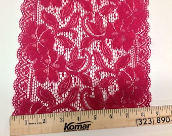 May include: Red lace trim with a floral pattern. The lace is approximately 6 inches wide.