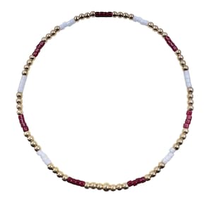 May include: A beaded bracelet featuring a circular design. The bracelet is composed of small, gold-colored beads interspersed with white and burgundy beads. The beads are strung together to form a flexible band.