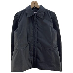 May include: A black quilted jacket with a zipper closure and knit sleeves.