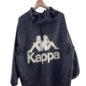 May include: A black hooded jacket with a white Kappa logo featuring two figures sitting back-to-back.