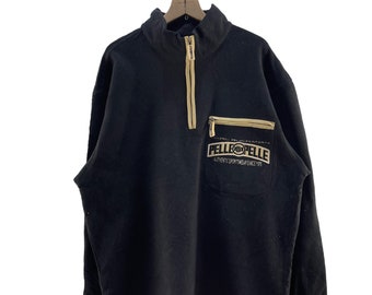 May include: Black fleece pullover with a zipper and a kangaroo pocket. The pocket has a brown patch with the text "PELLE PELLE" and "AUTHENTIC SPORTSWEAR SINCE 1978".