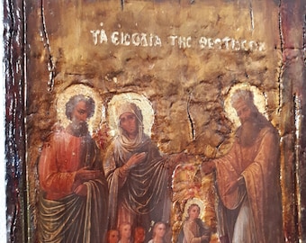 May include: A vintage-style religious icon painting depicting a scene from the Bible. The painting features a group of people, including a woman in a blue robe and a man in a red robe, standing in front of a golden background. The painting is framed in a dark wood frame and has a distressed, textured surface. The text "ΤΑ ΕΙΔΟΛΑ ΤΗΣ ΘΕΣΣΑΛΟΝΙΚΗΣ" is written at the top of the painting.