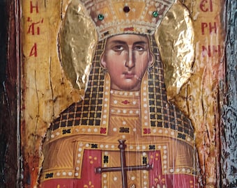 May include: A rectangular wooden icon painting featuring a figure wearing a tall, ornate crown and red and gold robes. The figure holds a dark cross in one hand. Gold leaf accents surround the head. Greek text is visible on both sides.