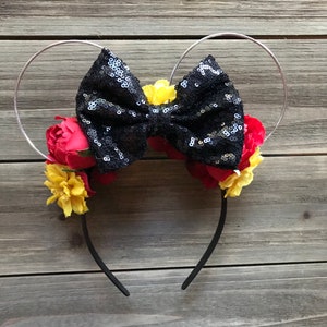 May include: Black sequin bow with red and yellow flowers on a silver headband.