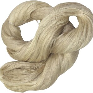 May include: A skein of natural beige linen yarn, perfect for knitting or crocheting.
