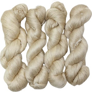 May include: Three skeins of beige yarn, each skein is twisted and tied into a knot.