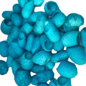 May include: A pile of blue silk cocoons, a natural material used for crafting and textile production.