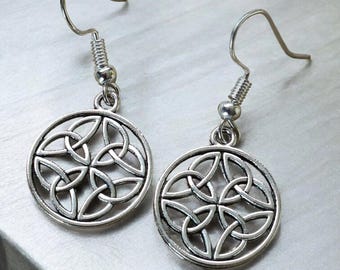 May include: A pair of silver Celtic knot earrings with a circular design. The earrings have a simple hook closure.
