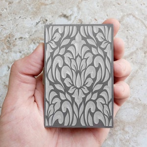 Back Side View of Floral Design on Engraved Stainless Steel Credit Card Case in hand
