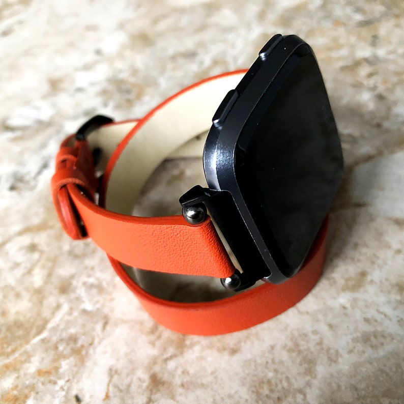 orange fitbit versa band