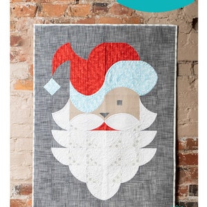 May include: A red, white, and blue geometric Santa Claus quilt block pattern. The pattern is called "Posh Santa" and is part of the "Sew Kind of Wonderful" collection. The pattern number is #442.
