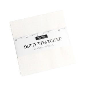 May include: A stack of off-white fabric squares, wrapped with a white label. The label features the text "DOTTY THATCHED" and "BY ROBIN PICKENS" in black, with the "moda FABRICS & SUPPLIES" logo. A ruler graphic is printed on the label.