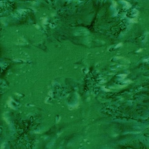 May include: A close-up of a green fabric with a mottled pattern. The fabric has a textured appearance with varying shades of green, creating a natural, organic look. The design resembles a watercolor painting or a natural landscape.