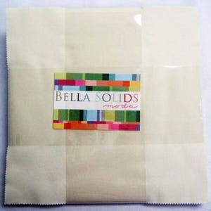 May include: A package of off-white fabric squares with a label that reads "Bella Solids moda".
