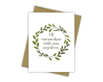 May include: A white card with a green leafy wreath around the text "I'll remember with you anytime."