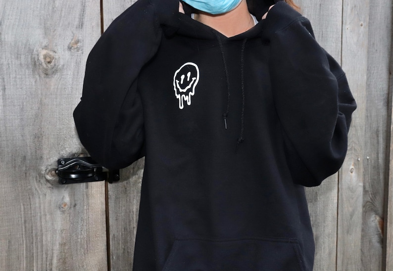 black hoodie with smiley faces