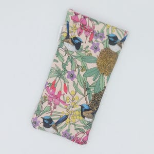 May include: A pink fabric pouch with a floral pattern featuring blue birds and yellow flowers. The pouch is made of a soft, durable fabric and is ideal for storing small items.