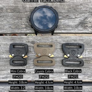 May include: Three different colored Cobra buckle styles: black, coyote brown, and mini black. Each buckle has the Cobra logo and the text "FM25" or "FM20". The buckles are shown on a wooden surface.