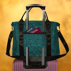 Dark teal trolley sleeve tote, lightweight weekender bag with luggage sleeve, artistic paint drips printed underseat travel bag