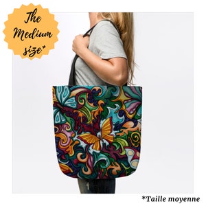 May include: A colorful tote bag with a swirling pattern of butterflies and floral designs. The bag is made of canvas and has a black handle. The text "The Medium size*" is on a yellow star in the top left corner. The text "*Taille moyenne" is at the bottom of the image.