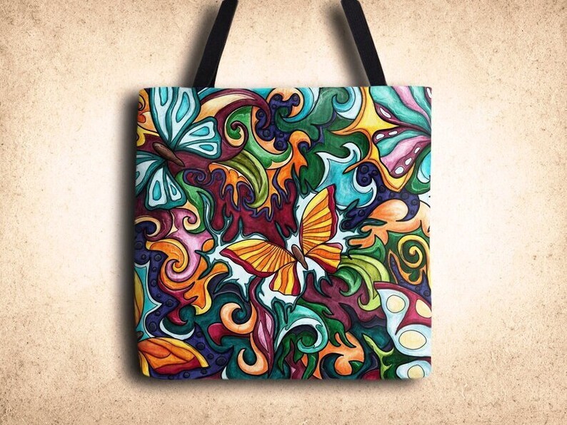 May include: A colorful tote bag with a whimsical design featuring butterflies and swirls in shades of blue, green, yellow, orange, pink, and purple.